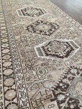 an antique heriz runner with a neutral palette and subtle sea green accents