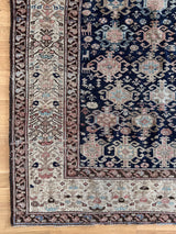 an antique malayer rug with midnight blue field and soft pink accents