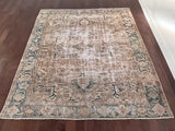 a large antique heriz rug with neutral cream and blue accents